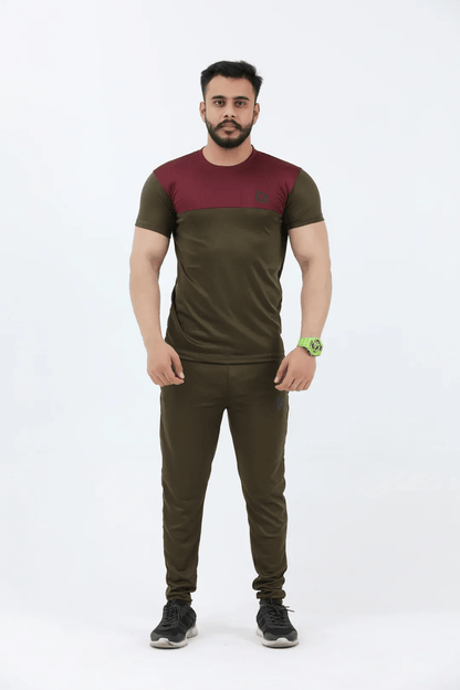 Man wearing a green and maroon athletic outfit on a white background