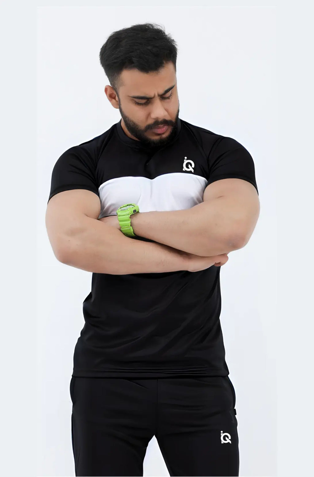 Man wearing a black athletic outfit with a logo on a white background