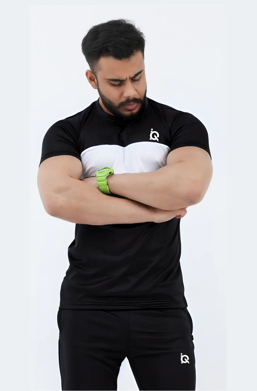 Man wearing a black athletic outfit with a logo on a white background